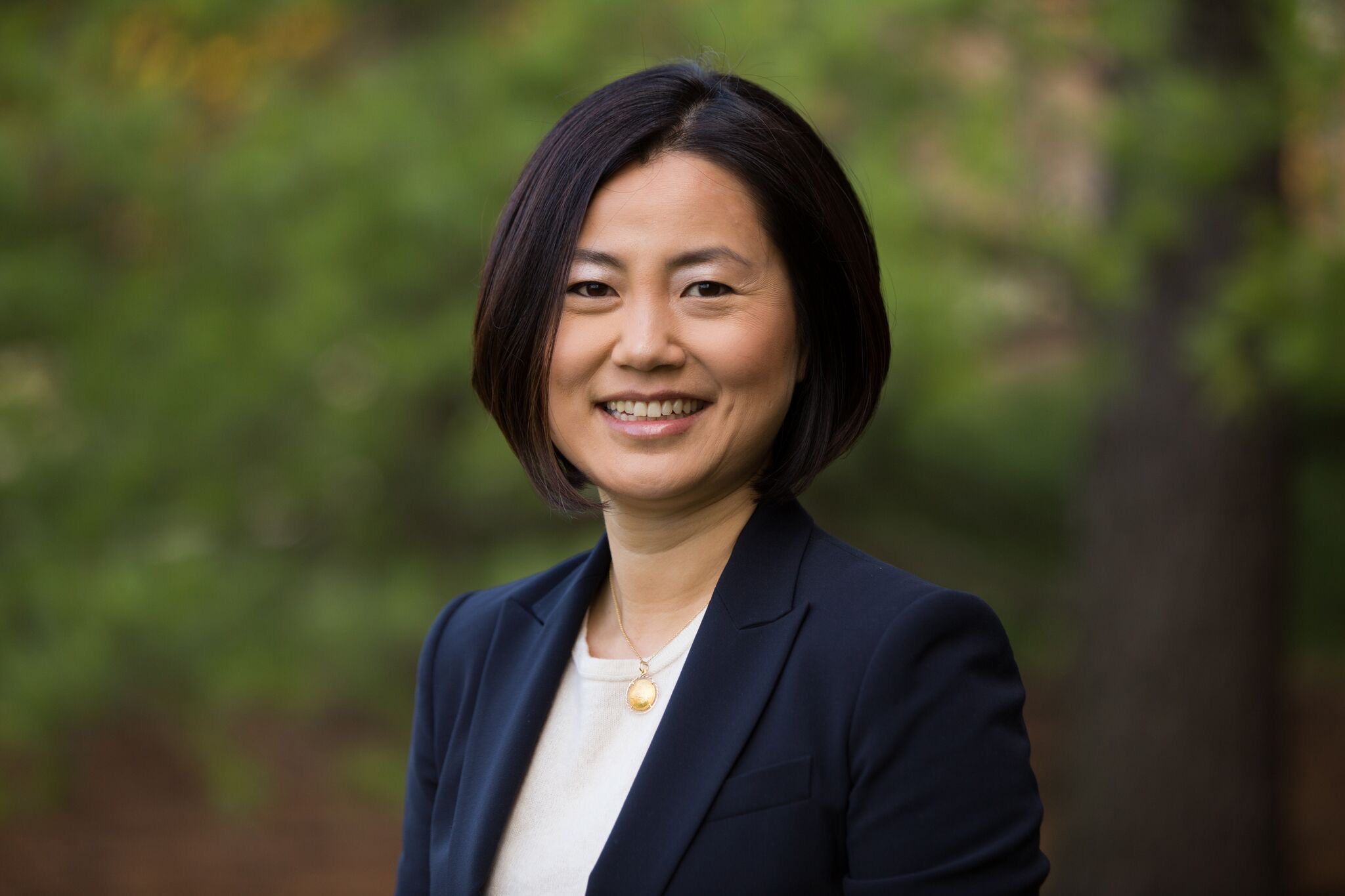 A portrait of a woman posing outdoors.