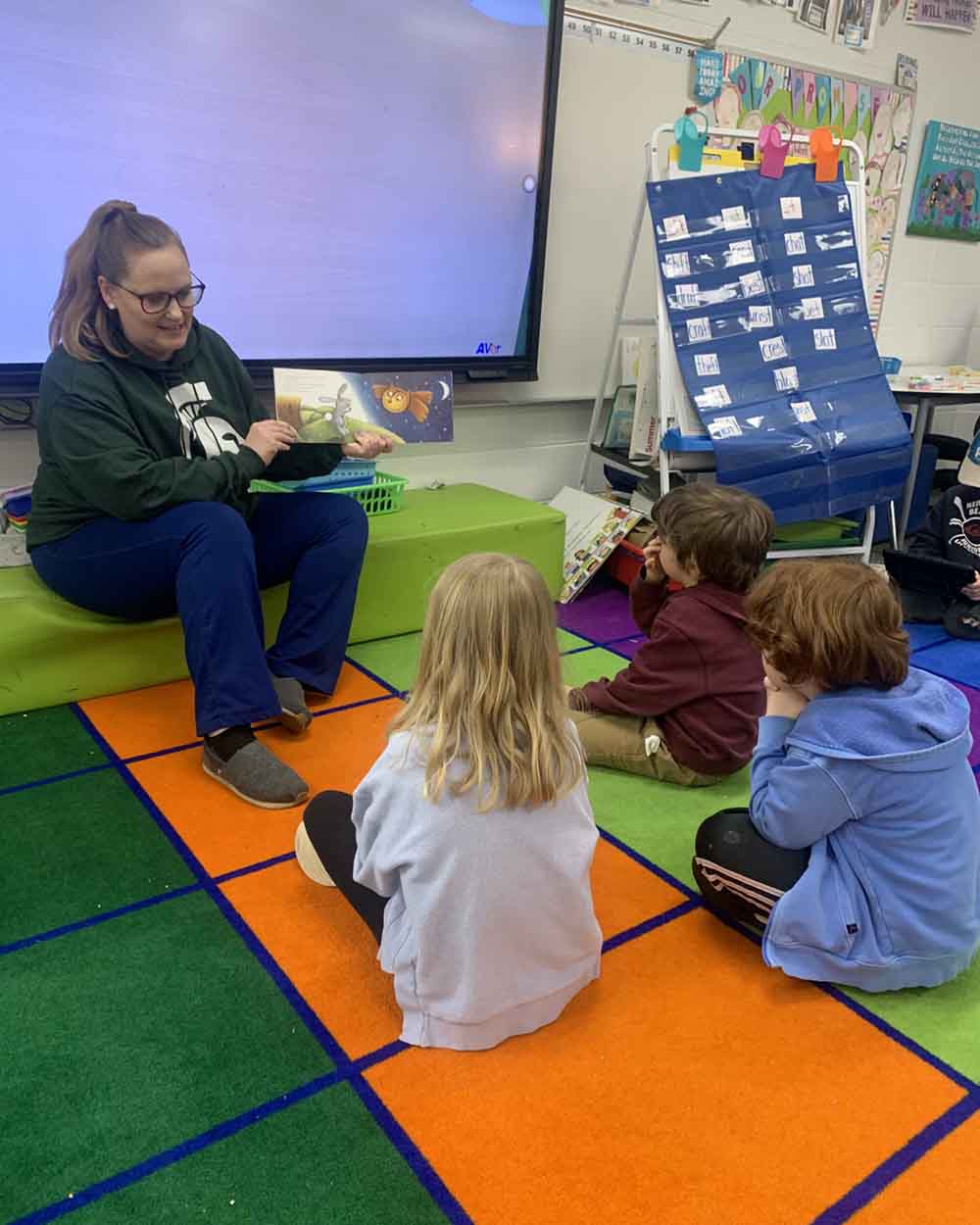 Maggie Scheurer with elementary school students