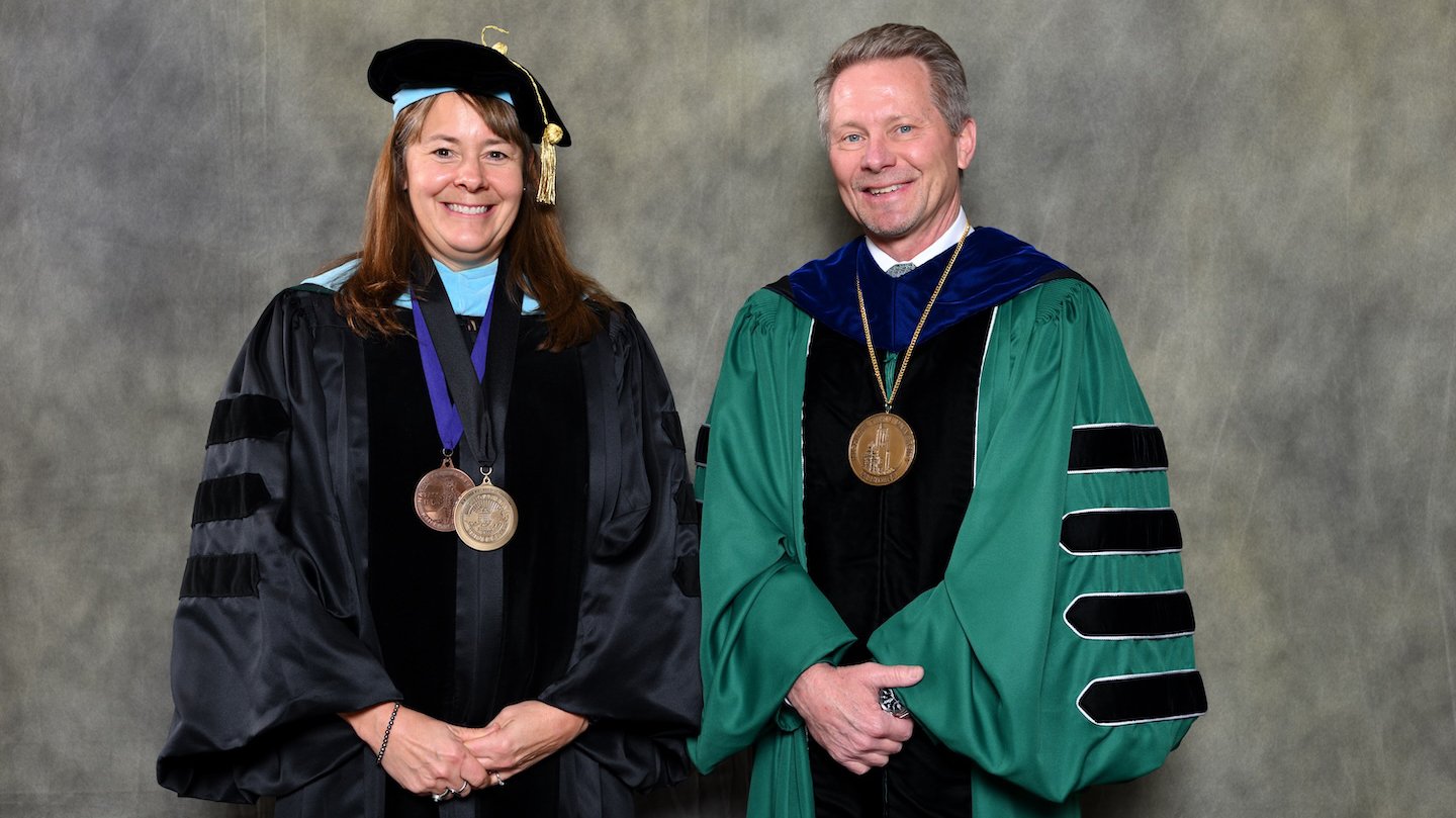 Endowed faculty member Karin Pfeiffer with MSU President Kevin Guskiewicz.