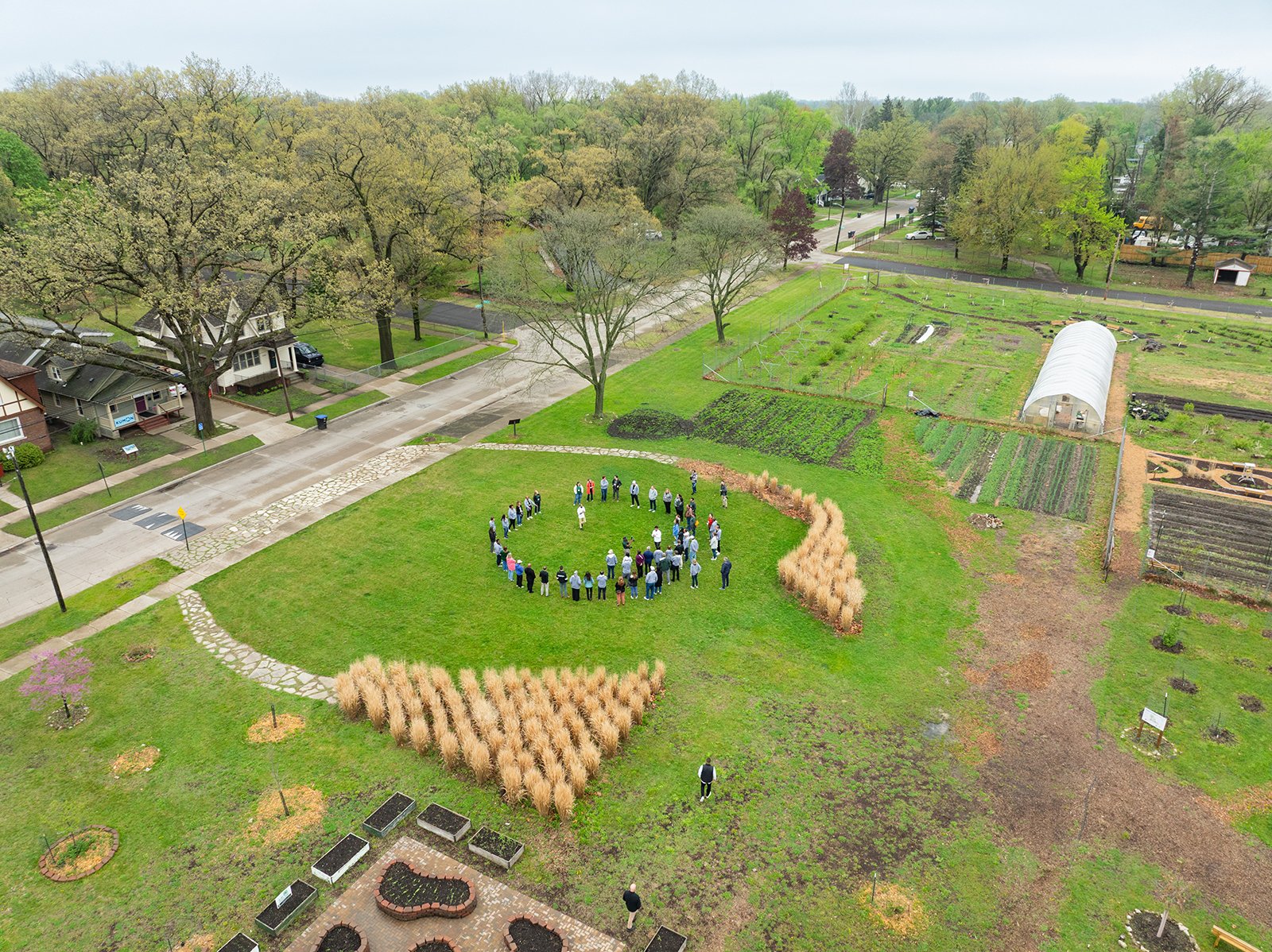 Aerial photo of people in a circle at an urban farm.
