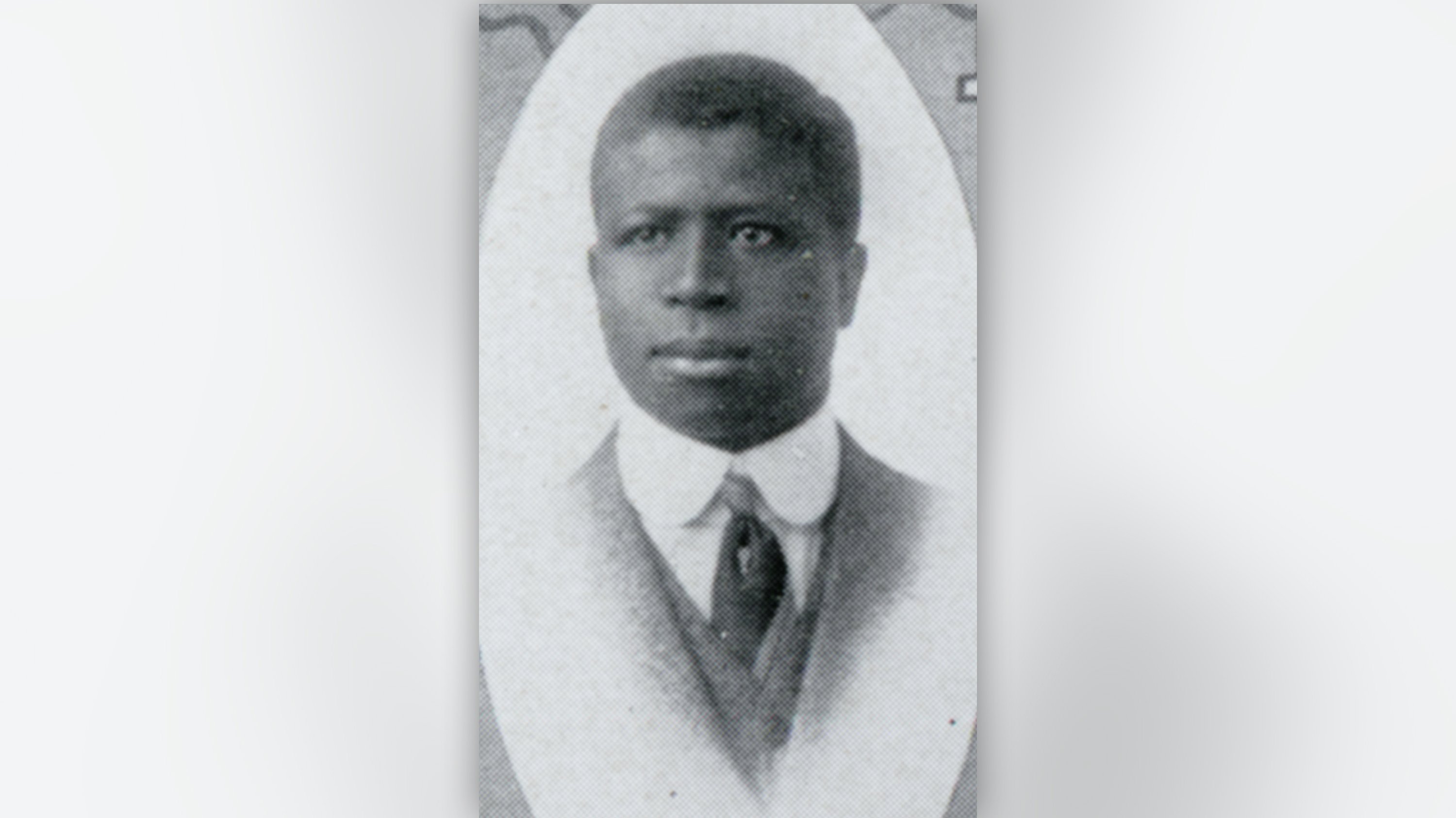 A black and white portrait of a man.