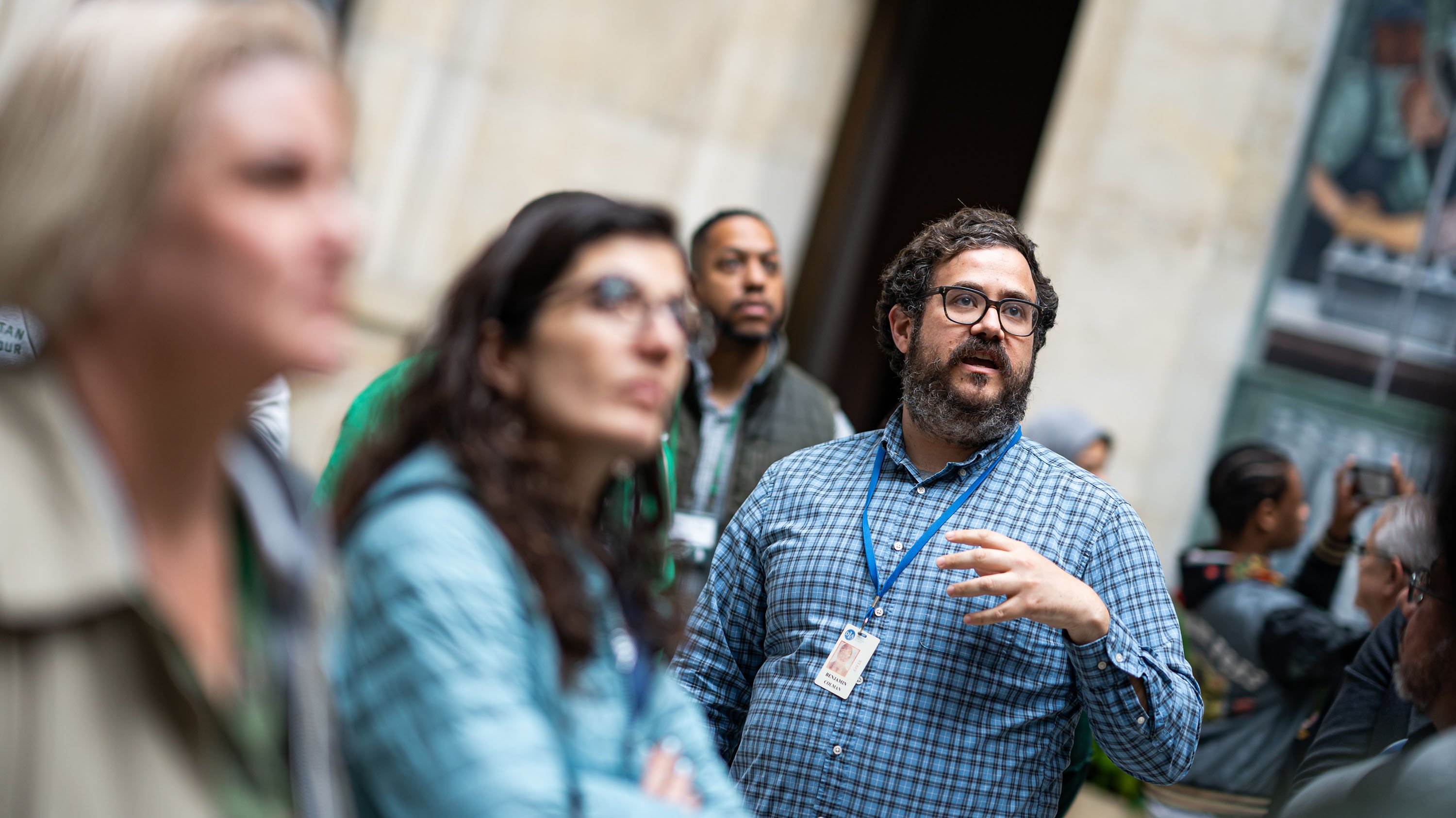 A man speaks as a group of people listen