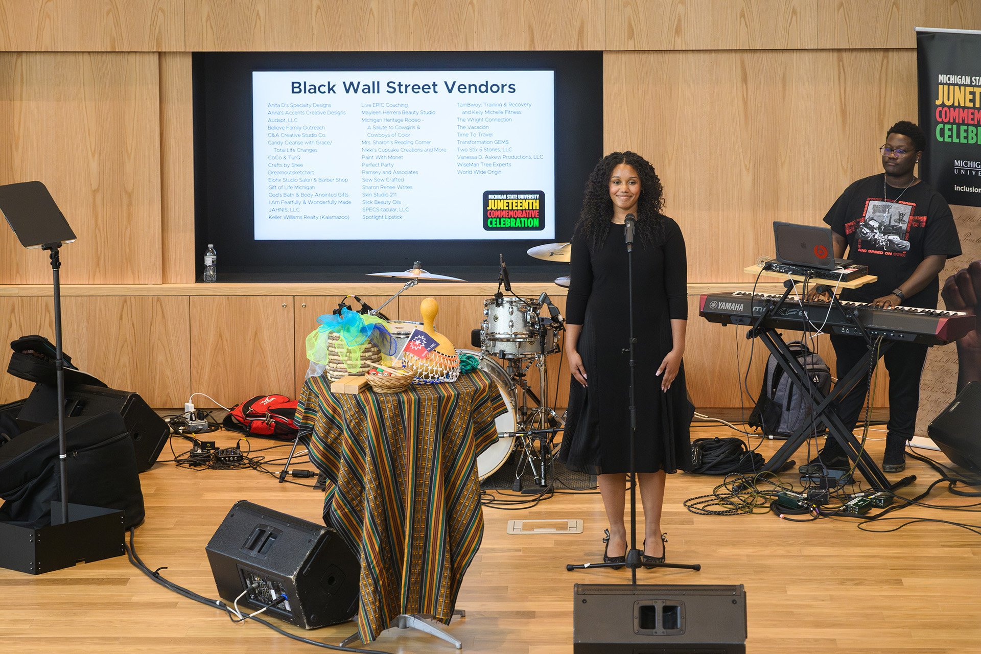 A singer stands at the mic to perform Lift Every Voice and Sing at the MSU Juneteenth Celebration