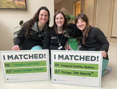 Rotating interns Kimberley Barbeitos de Sousa, Rachel DuBose, and Morgan Uebelhor are joined by facility dog Appa.