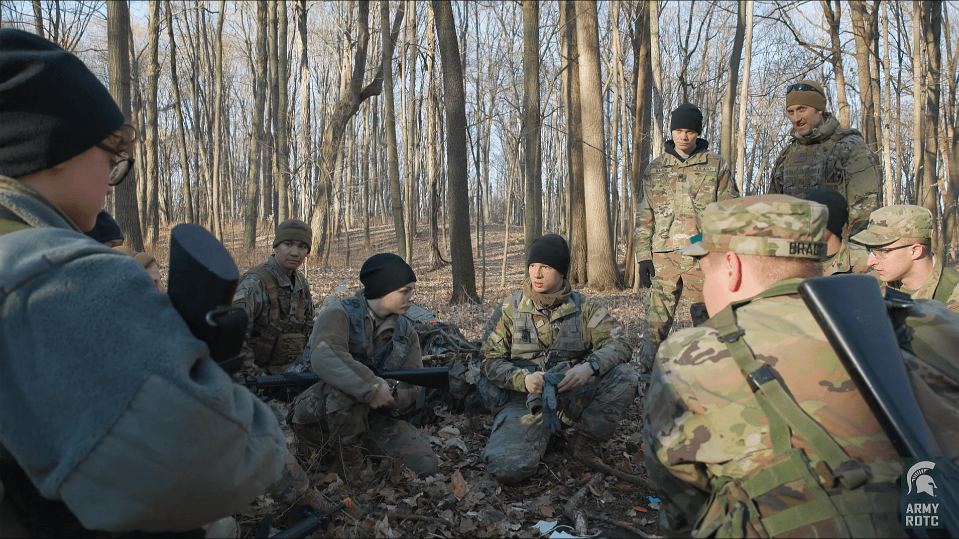 cadets gather in a wooded area