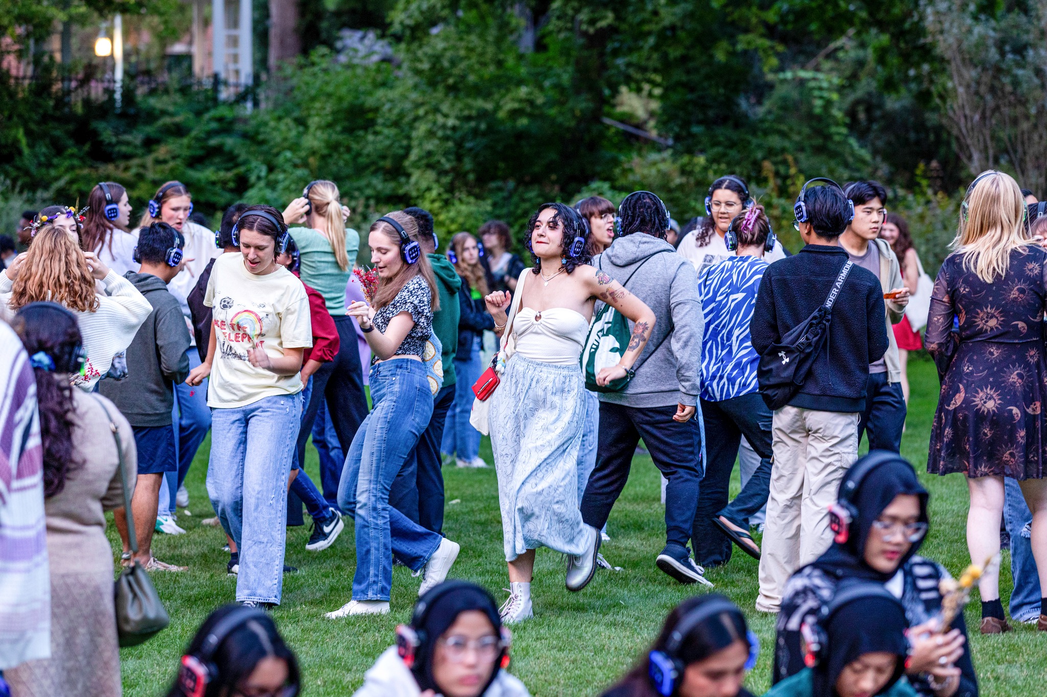 group of people dancing in a garden