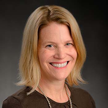 Heather Swain profile photo, shown wearing a dark top and a necklace