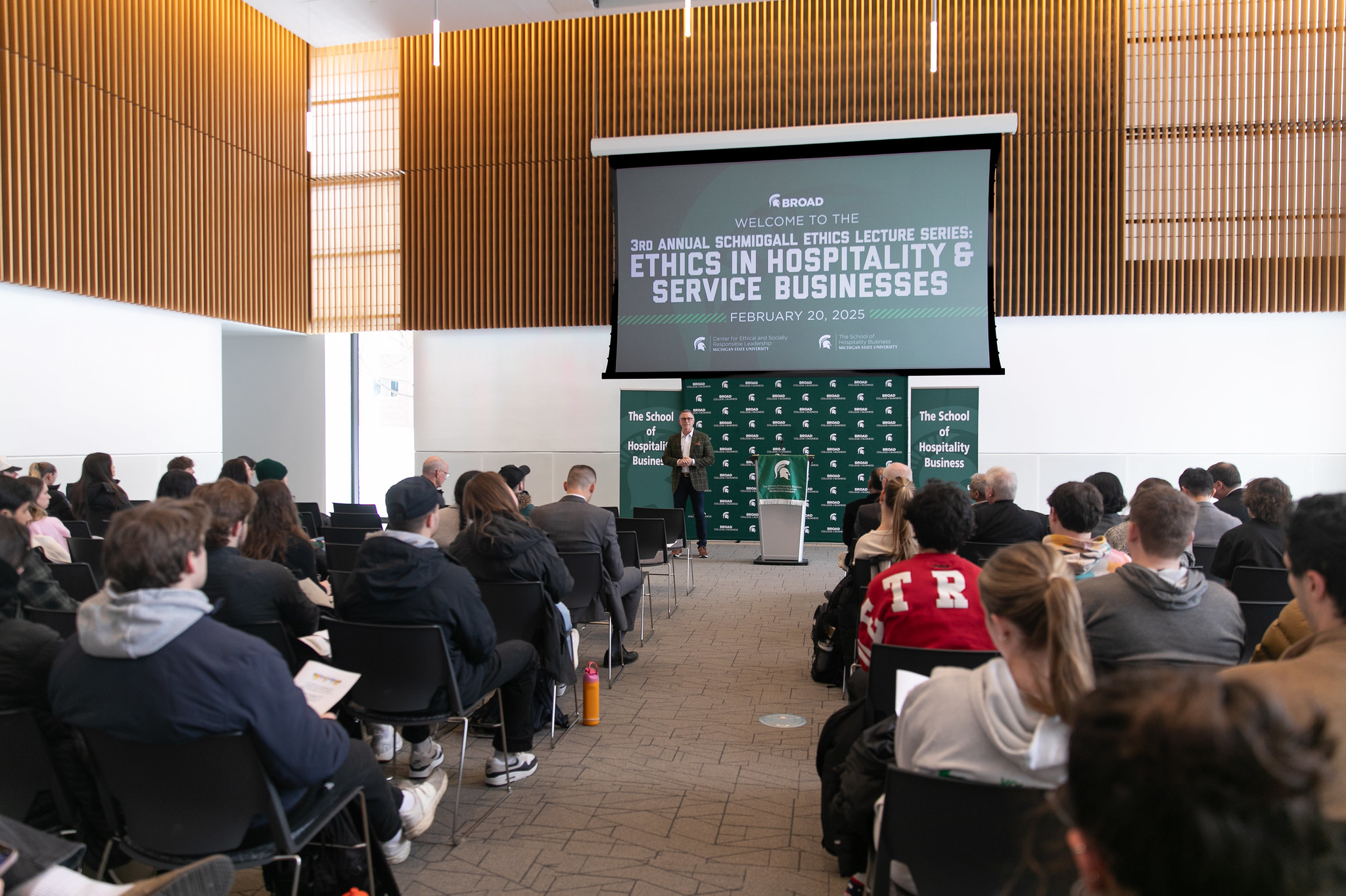 A speaker stands in front of a lecture hall during a Broad College of Business event during Ethics Week 2025.