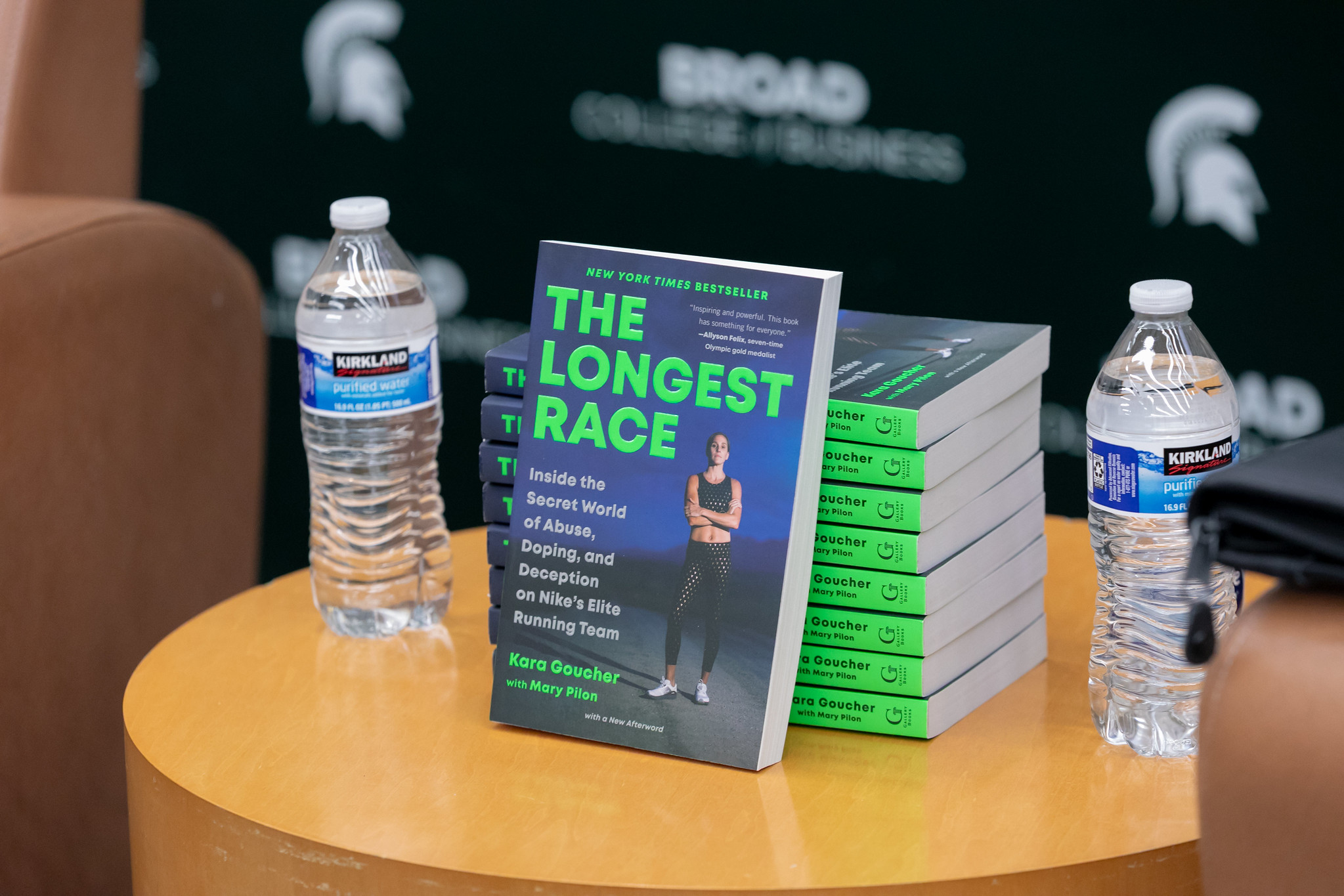 Kara Goucher's book, titled "The Longest Race," is propped up on a table with a stack of books behind it.