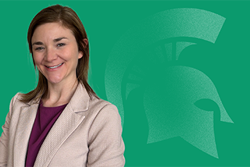 Headshot photo of Nikki Schmidtke on a green background with a faded Spartan helmet overlay.