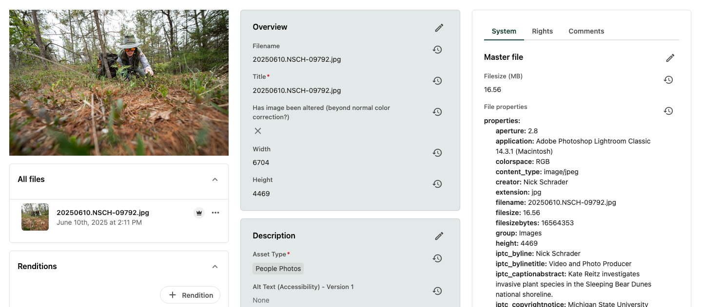 Screenshot of the asset details page showing a photo of a researcher crawling in the woods