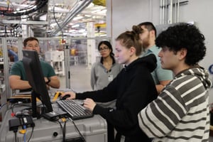 Group of individuals looking at a piece of equipment