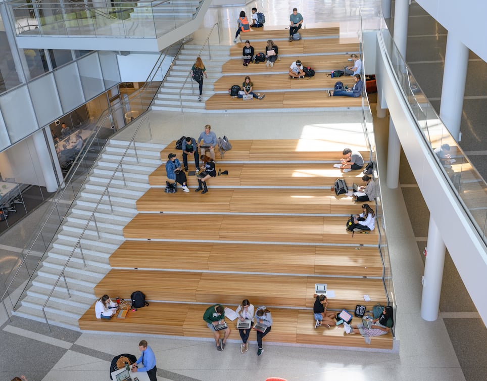 People sitting on the Minskoff pavilion building steps.