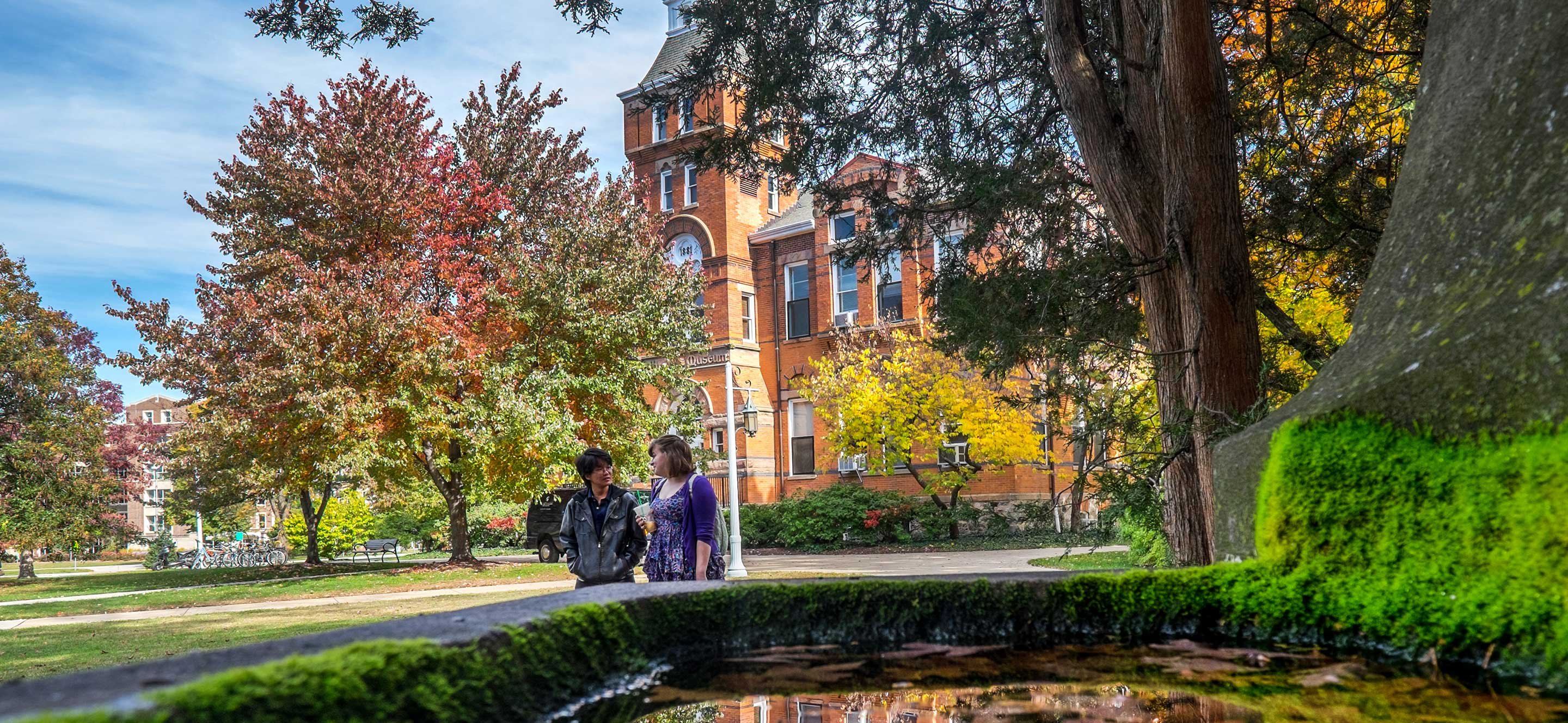 Students walking past fountain