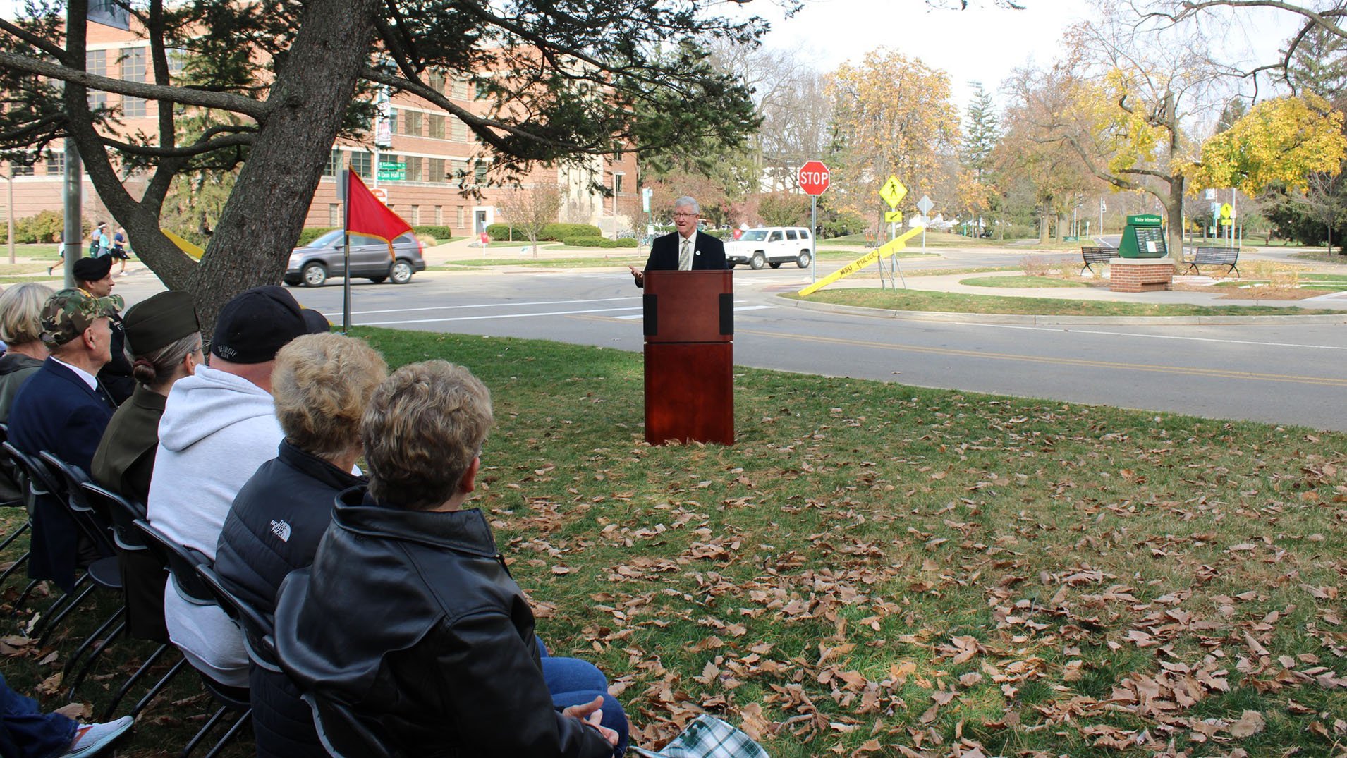 attendees at the Commemorative event listen to a speaker at the podium