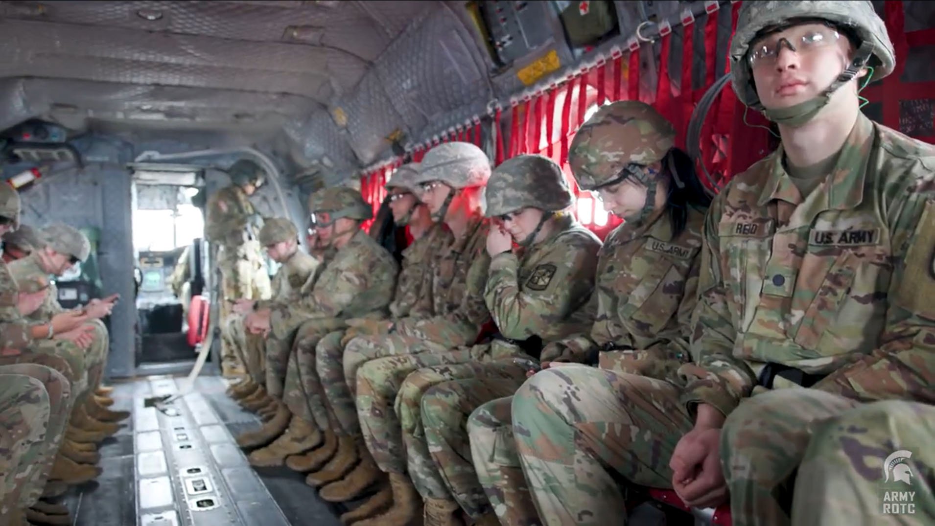 cadets sitting next to each other inside a helicopter