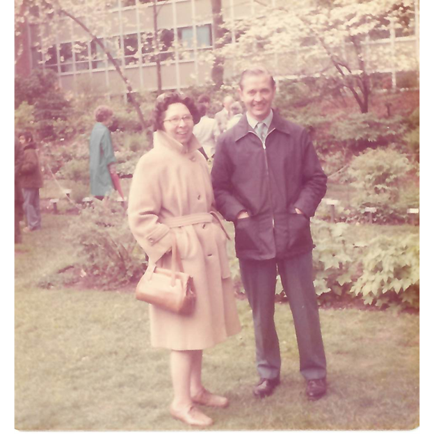 photo of a couple standing in a garden