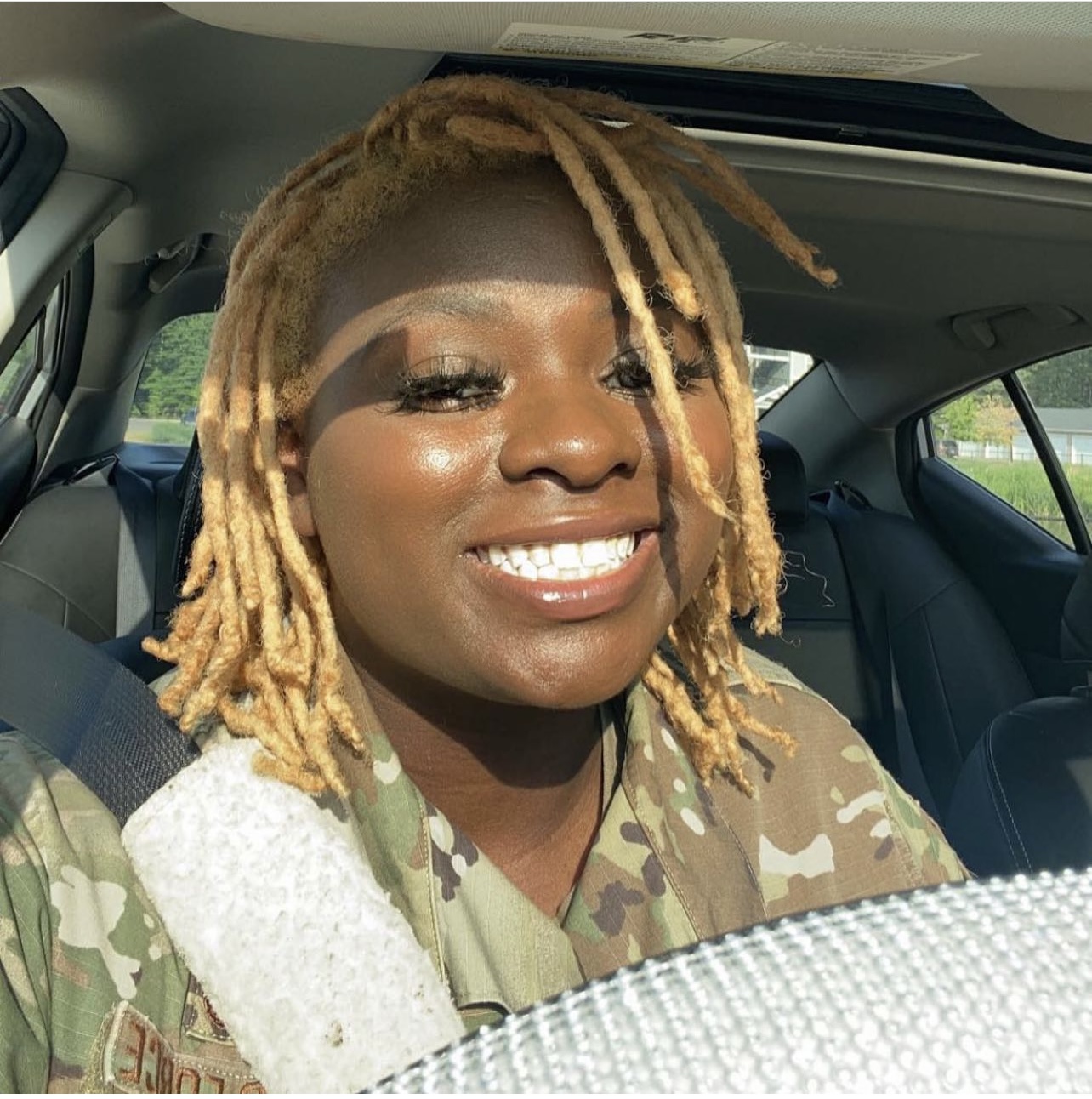 photo of young woman sitting in a car