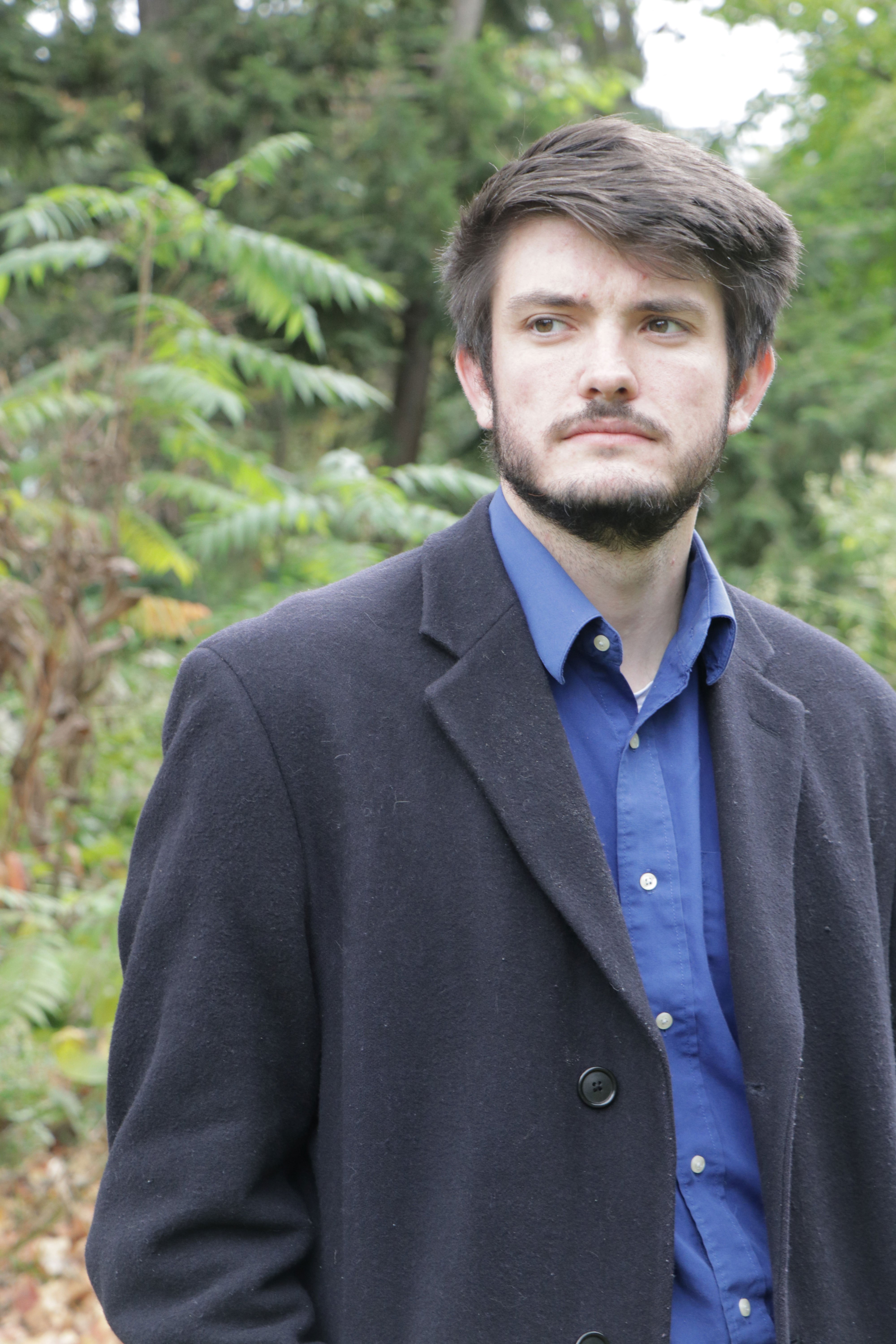 photo of young man with a beard in a suit