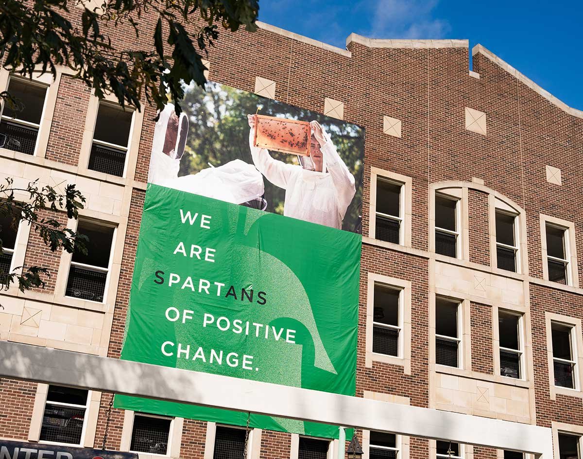 We are sPARTans of positive change banner on building