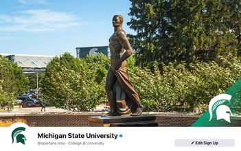 Facebook cover image featuring the Spartan statue in the foreground, Spartan Stadium in the background, and a semi-transparent green triangle in the right bottom corner with a white helmet on top.