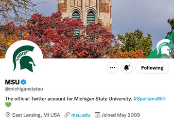 Twitter cover image featuring the top of Beaumont Tower surrounded by autumn tree leaves, and a semi-transparent green triangle in the right bottom corner with a white helmet on top.