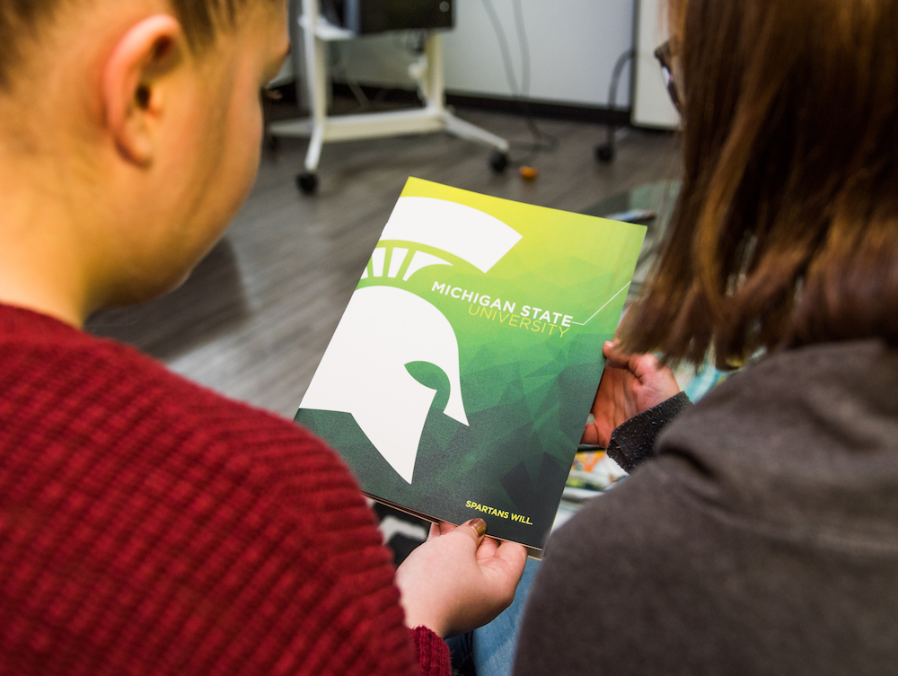 Two students looking at viewbook