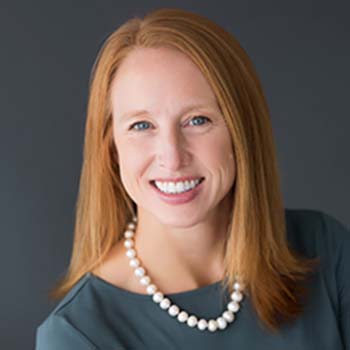 Emily Guerrant  profile photo, shown wearing a dark top and pearl necklace
