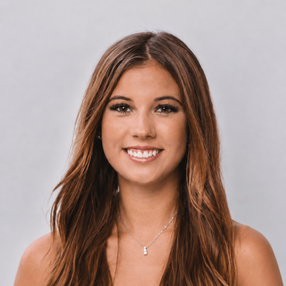 Headshot of Lacie Alt in front of a plain wall background.
