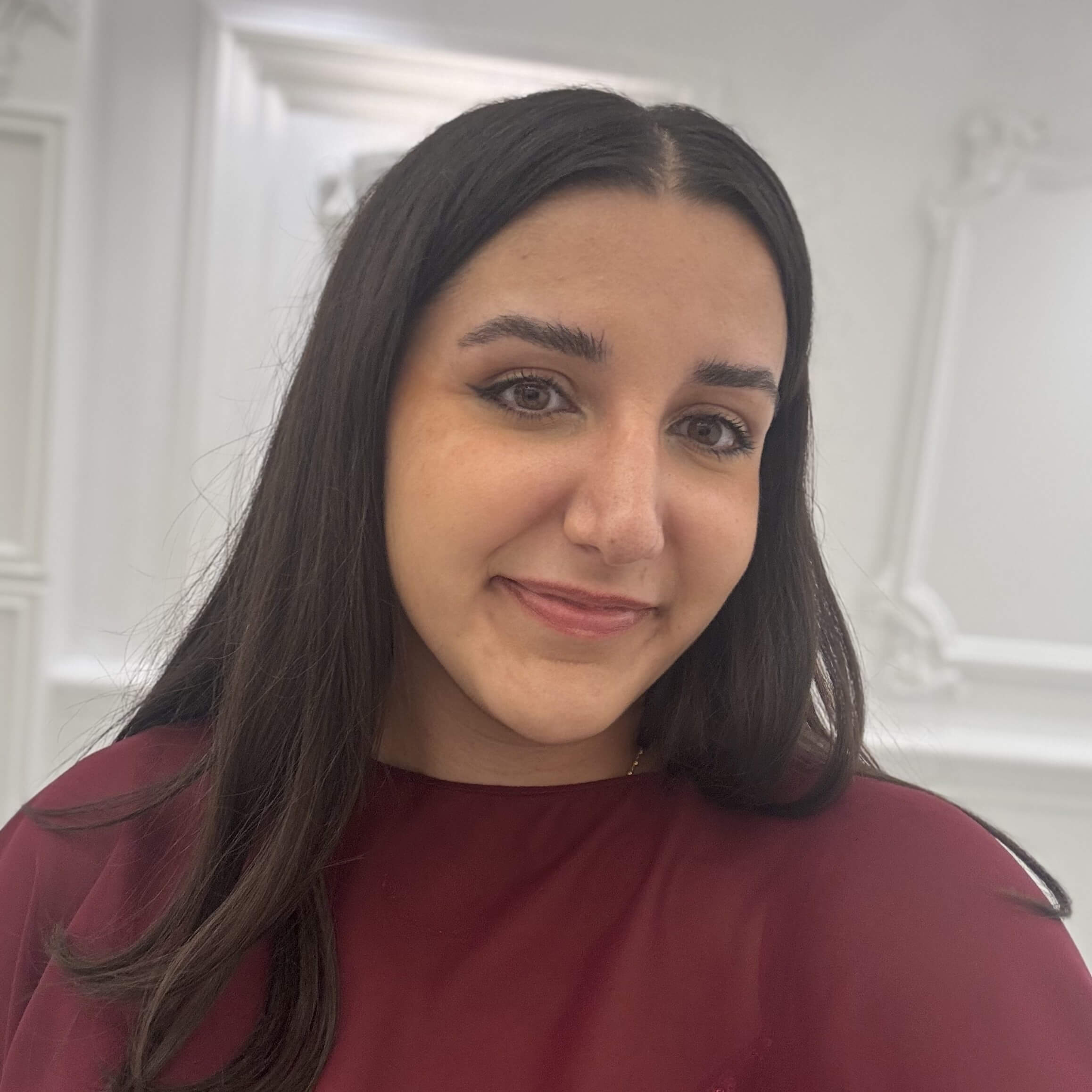 Headshot of Jessica Esho in front of an office background.