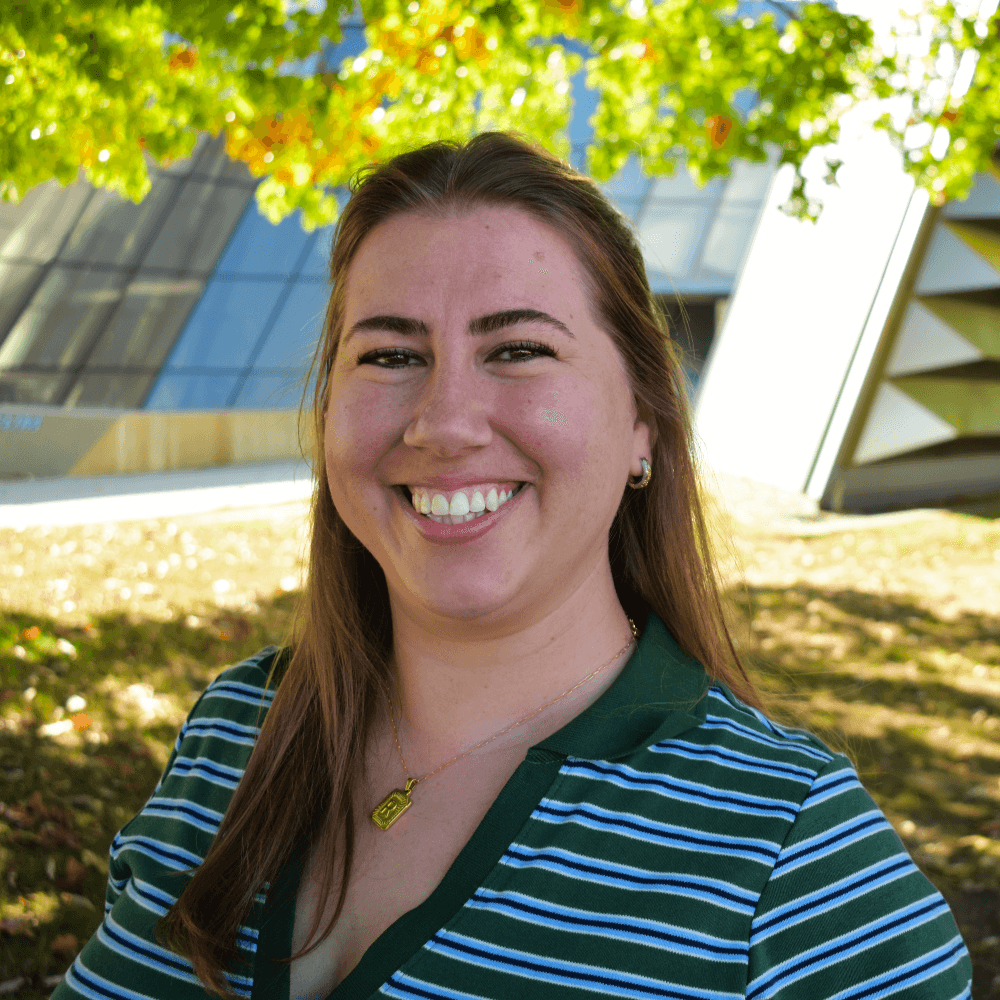 Dr. Rachel McNealey standing in front of the MSU Broad Art Musum on a sunny autum day.