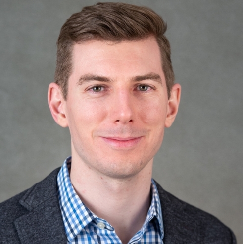 Headshot of Michael Aiello in front of a professional background.