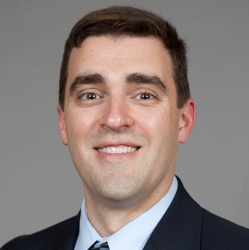 Headshot of Nick Corsaro in front of a professional background.