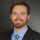 Headshot of Nathan Cronin in front of a professional background.