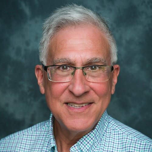 Headshot of Kevin Ford in front of a professional background.