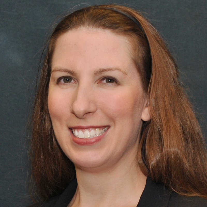 Headshot of Jennifer Gibbs in front of a professional background.