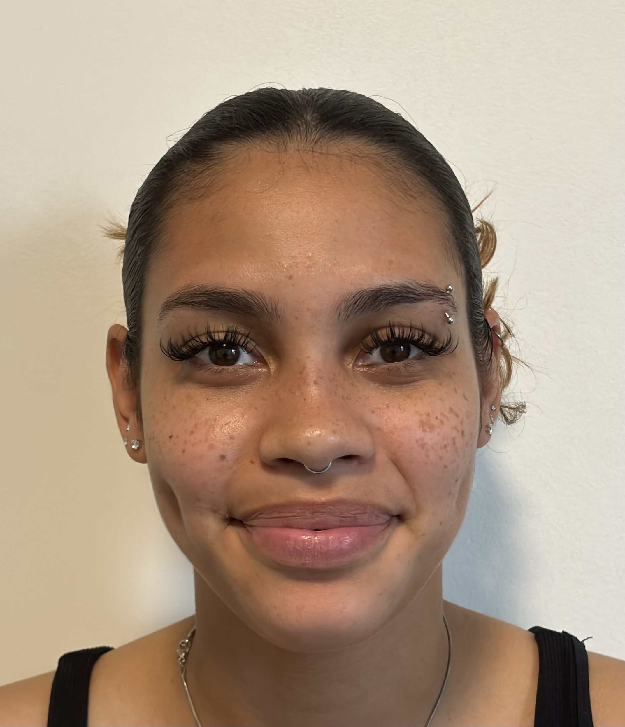 Headshot of Dayanara Gonzalez in front of a wall.