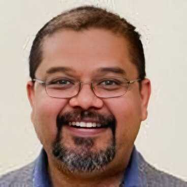 Headshot of Russell Hassan in front of a blank background.
