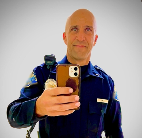 A headshot selfie of Shawn Hill in front of a wall.