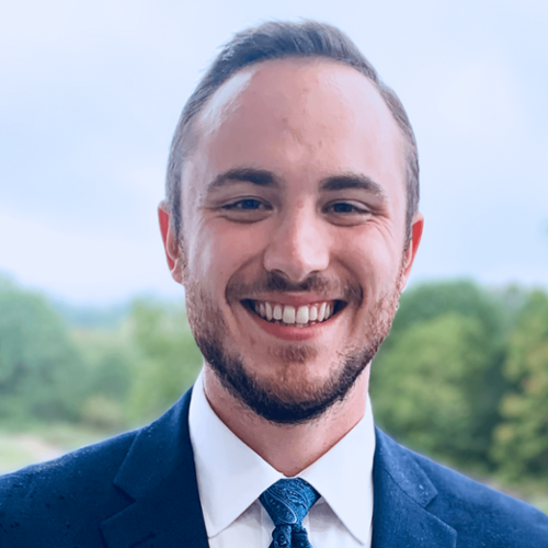 Headshot of Bradley O'Guinn in front of a nature background.