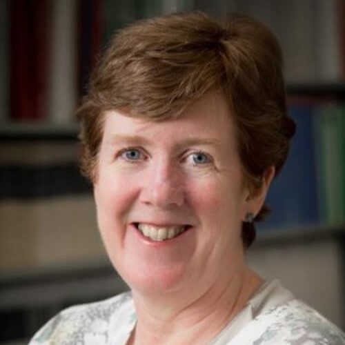 Headshot of Ann Marie Ryan in front of books.