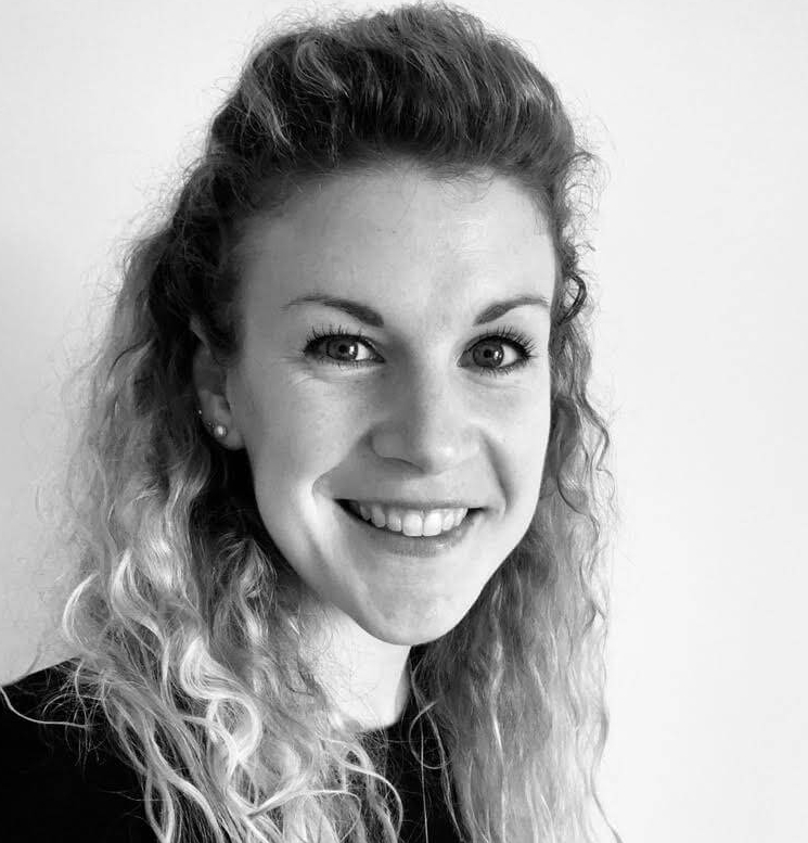 Headshot of Jemma Tyson in front of a wall.