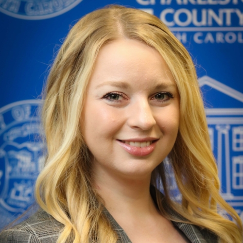 Headshot of Ashleigh Wojslawowicz in front of a banner background.
