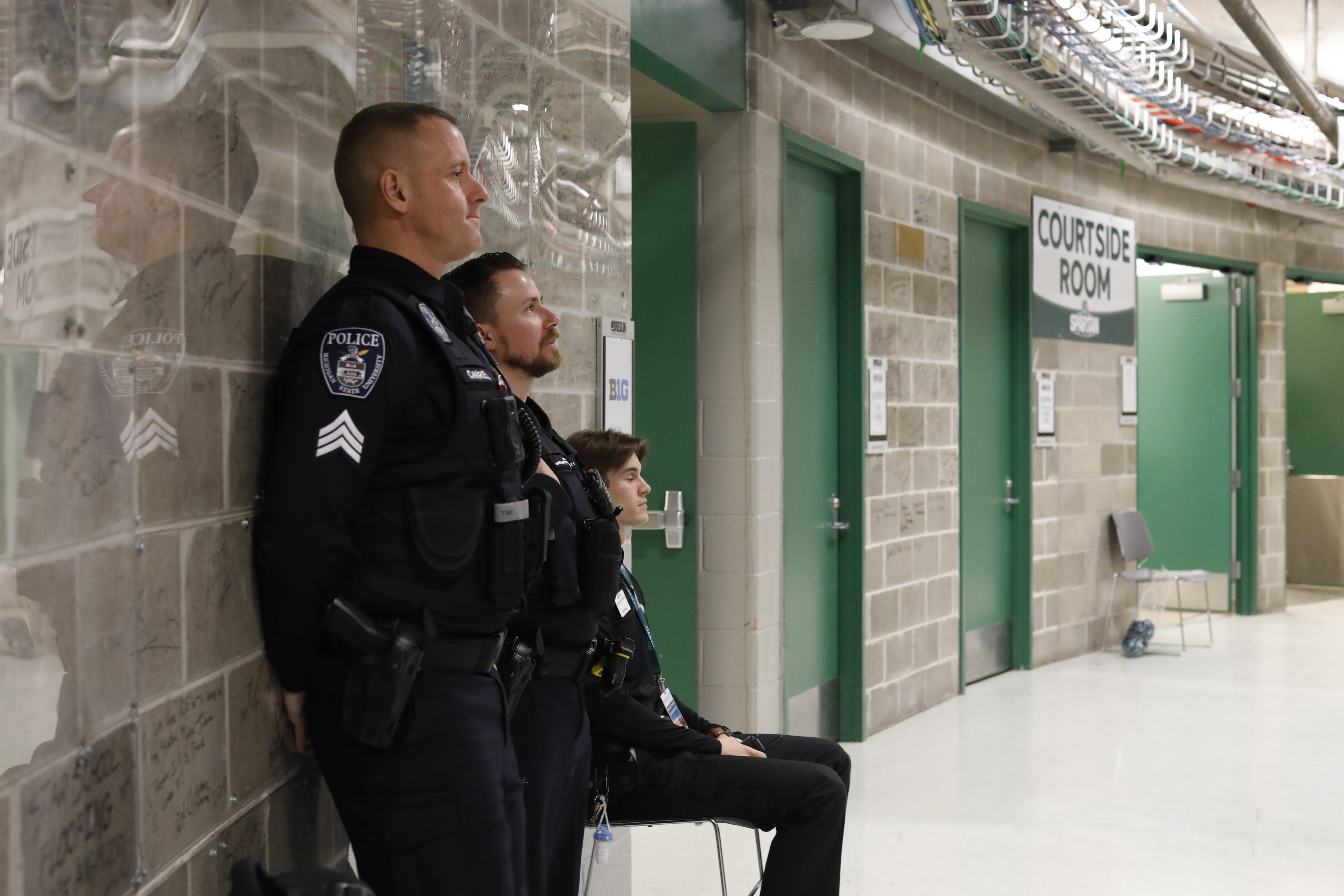 Officers standing near wall