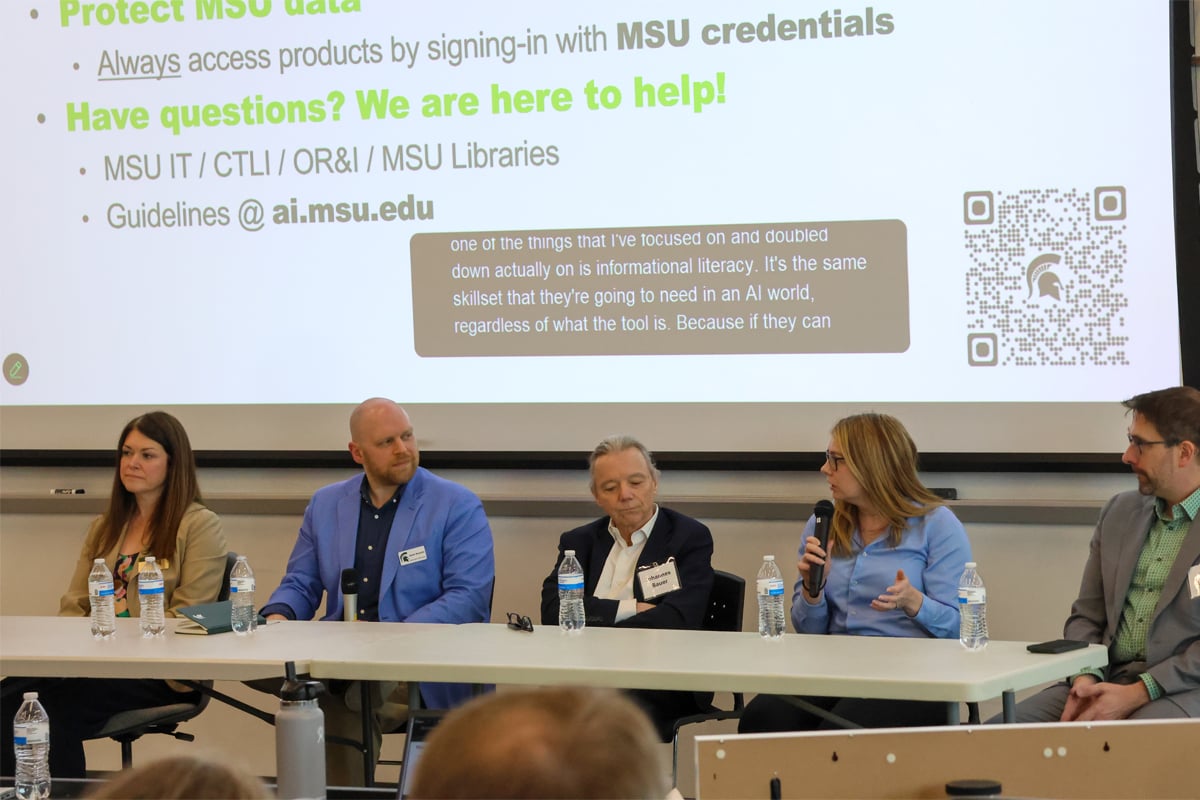 AI Summit panelists speaking while seated at a table.