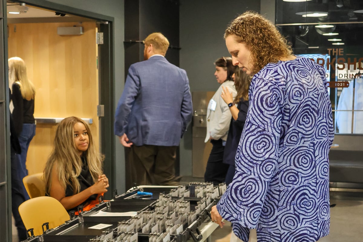 An AI Summit attendee at the registration table.