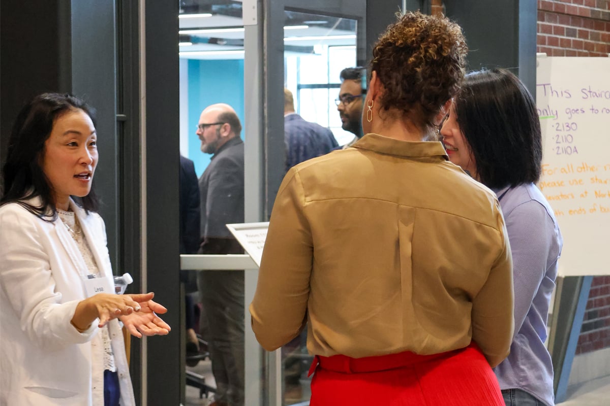 AI Summit attendees having a discussion during a break.
