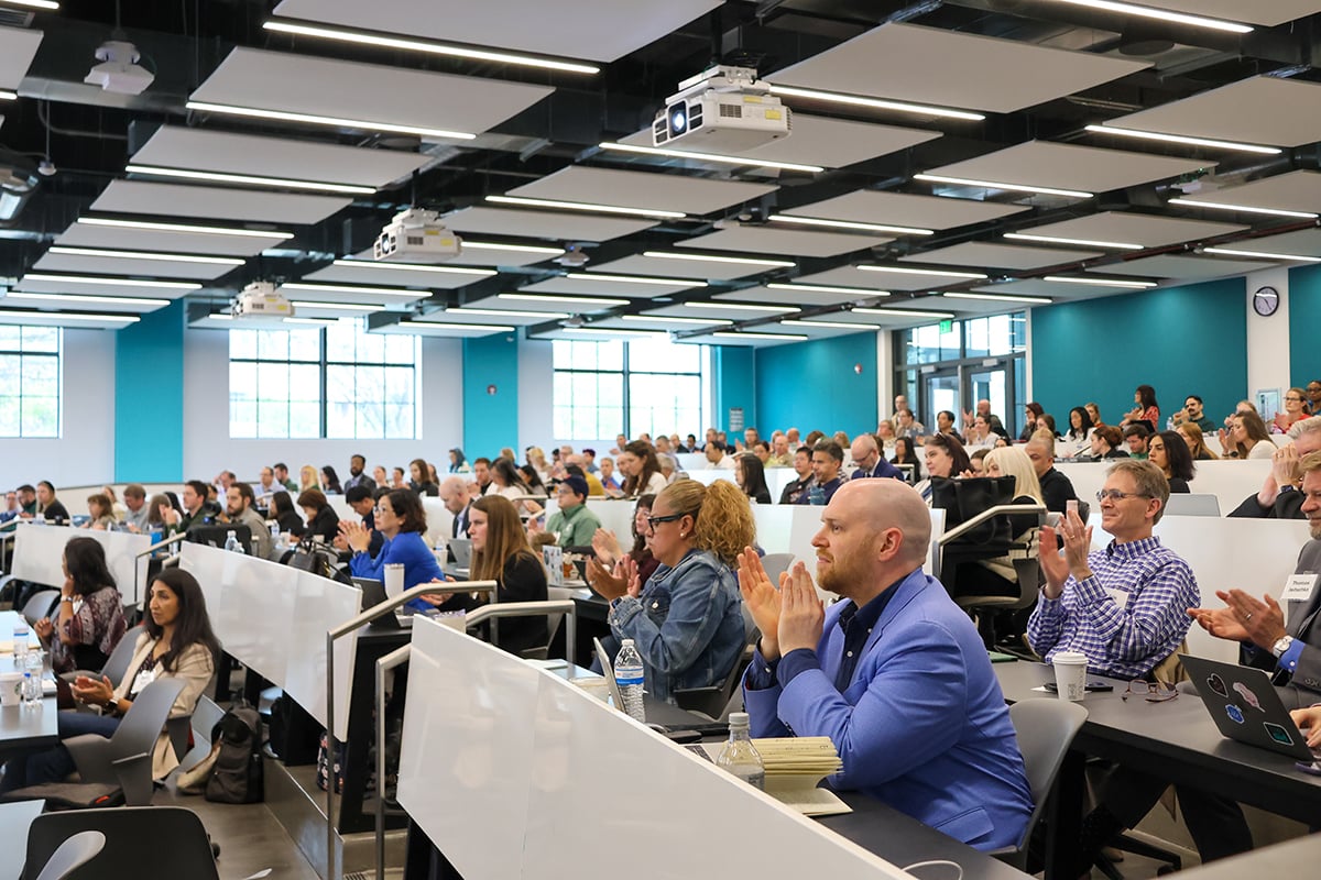 A wide view of AI Summit attendees seated in a classroom.