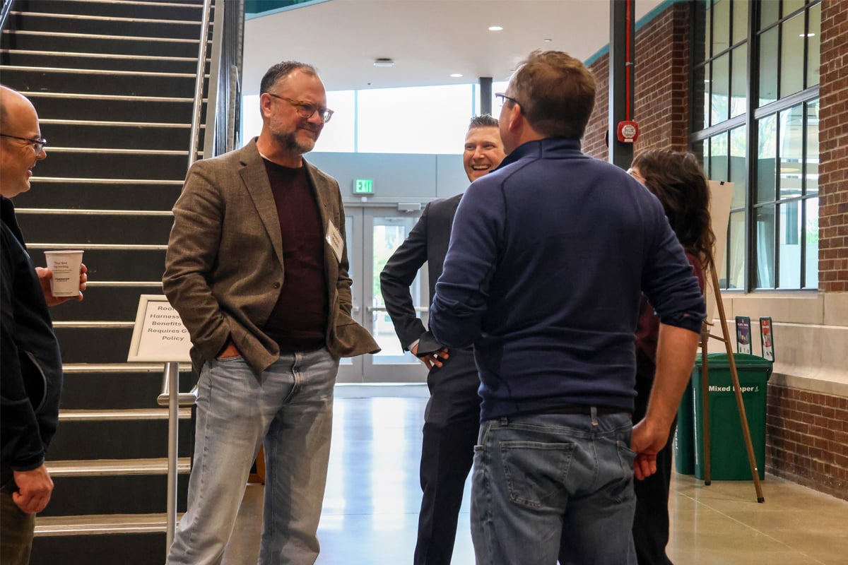 AI Summit attendees having a discussion during a break.