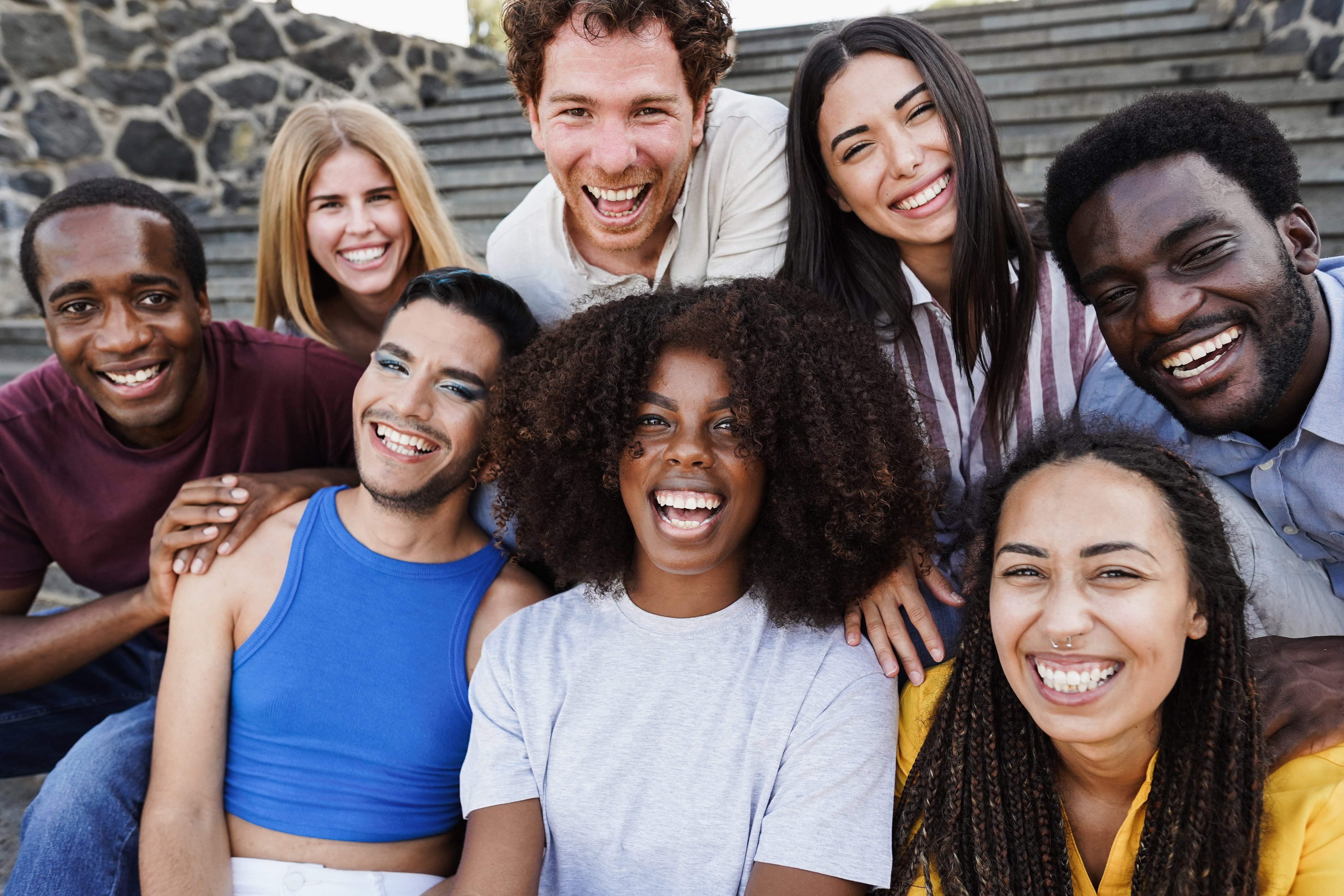 Group of people posing for a photo on stairs.